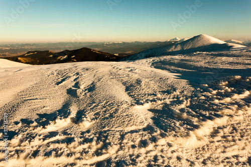 Landscape of snow winter valley and mountains on sunny day photo