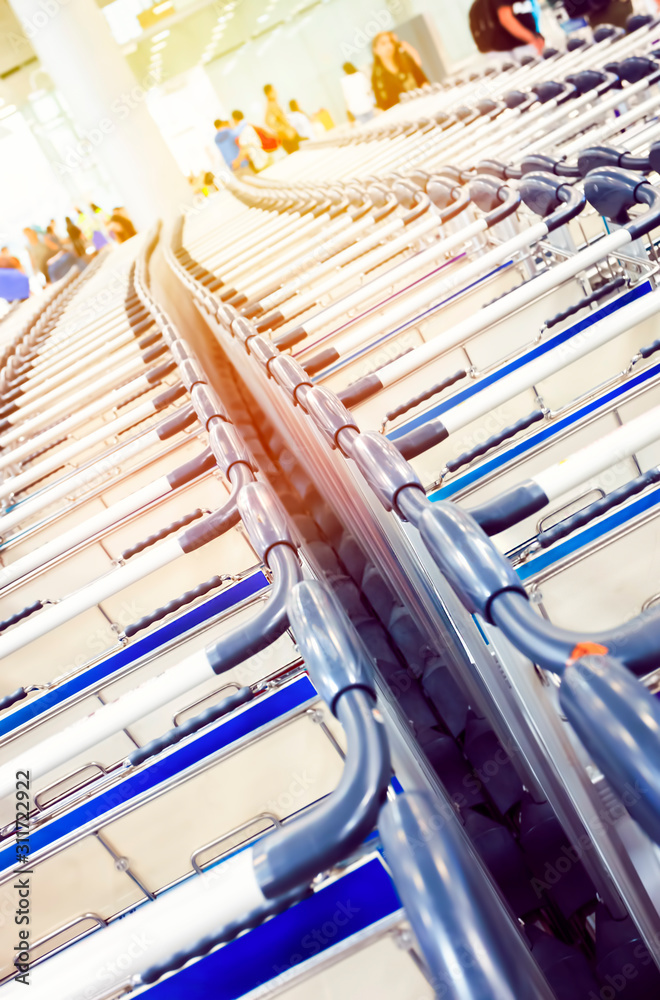 Fototapeta premium Rows of baggage trolleys in the building of the airport in retro style