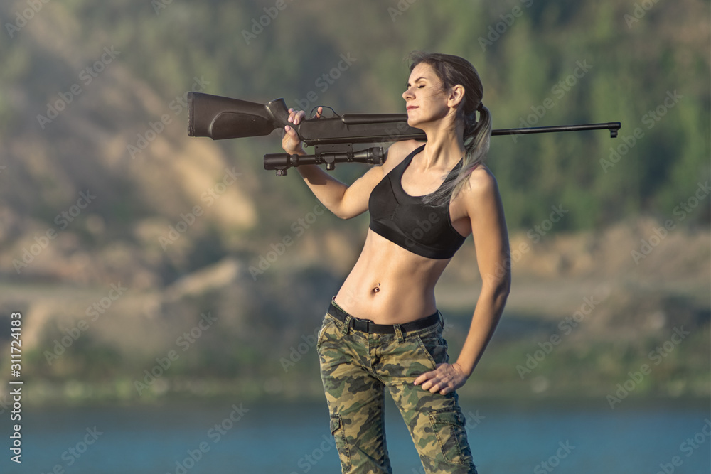 sexy military fashion girl with rifle with an optical sight. Female chase  sport hunter in forest with weapon. Stock Photo | Adobe Stock