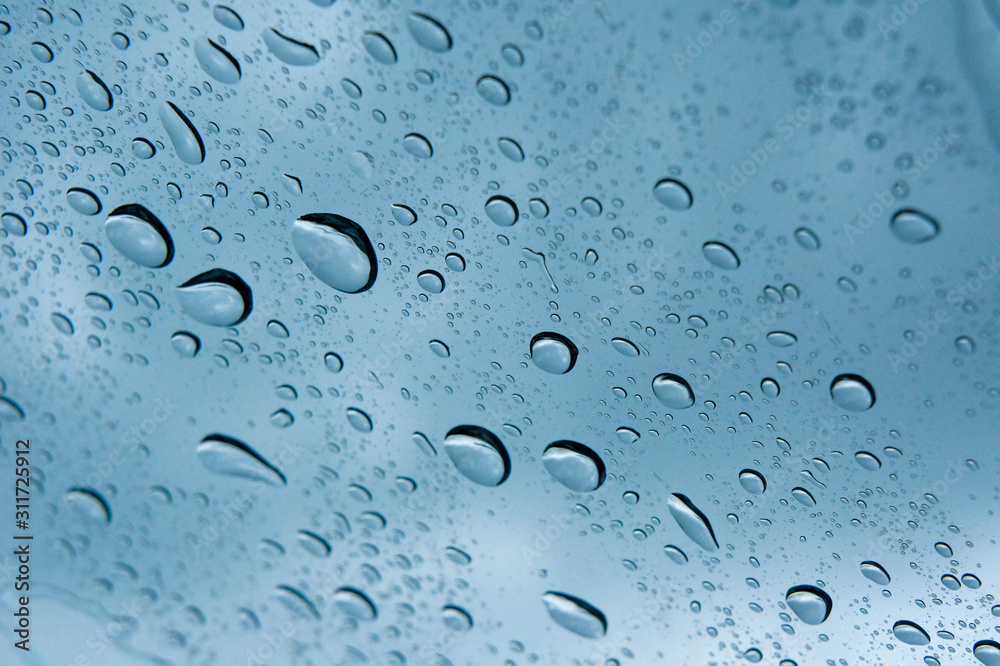 Water drop on a glass during raining season Water drop on a glass during raining season