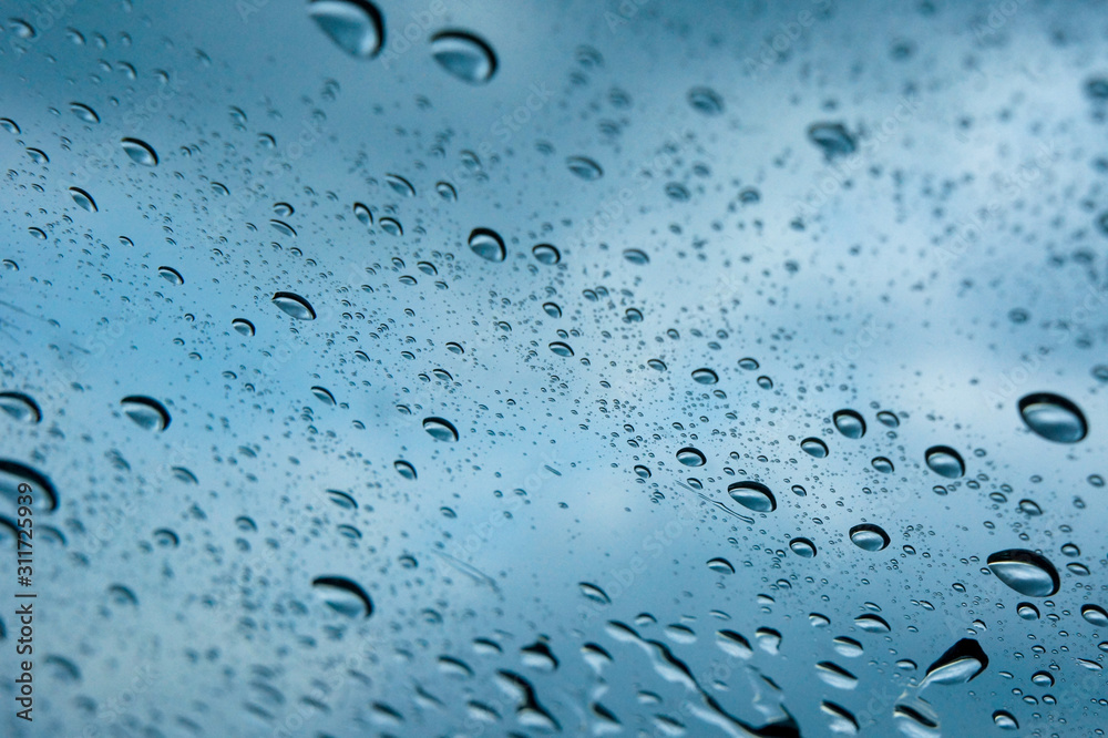 Water drop on a glass during raining season Water drop on a glass during raining season