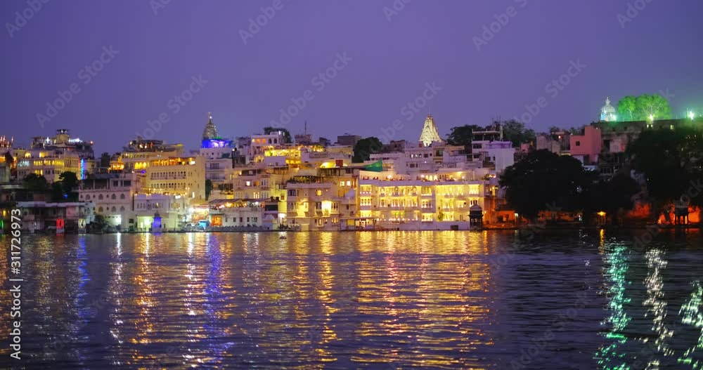 Lal ghat: Udaipur haveli, houses and ghats on bank of lake Pichola with water riffles. Rajput architecture. Sunset at Udaipur, Rajasthan, India. Lal ghat: Udaipur haveli, houses and ghats on bank of lake Pichola with water riffles. Rajput architecture. Sunset at Udaipur, Rajasthan, India.