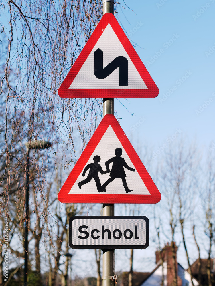 Double bend first to left sign and School children crossing sign. UK Road Traffic Triangular Warning Signs Double bend first to left sign and School children crossing sign. UK Road Traffic Triangular Warning Signs