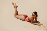 Woman enjoying sunny day on tropical beach.