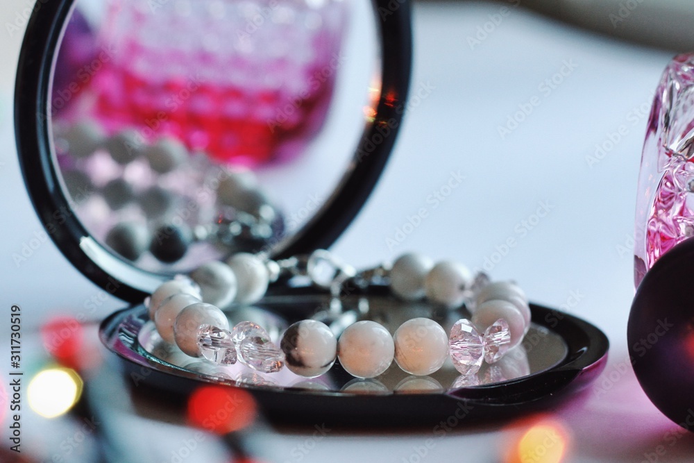 Jewelry composition with reflections in mirror with bokeh