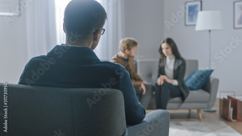 Photos Unfocused Couple on Counseling Session with Psychotherapist
