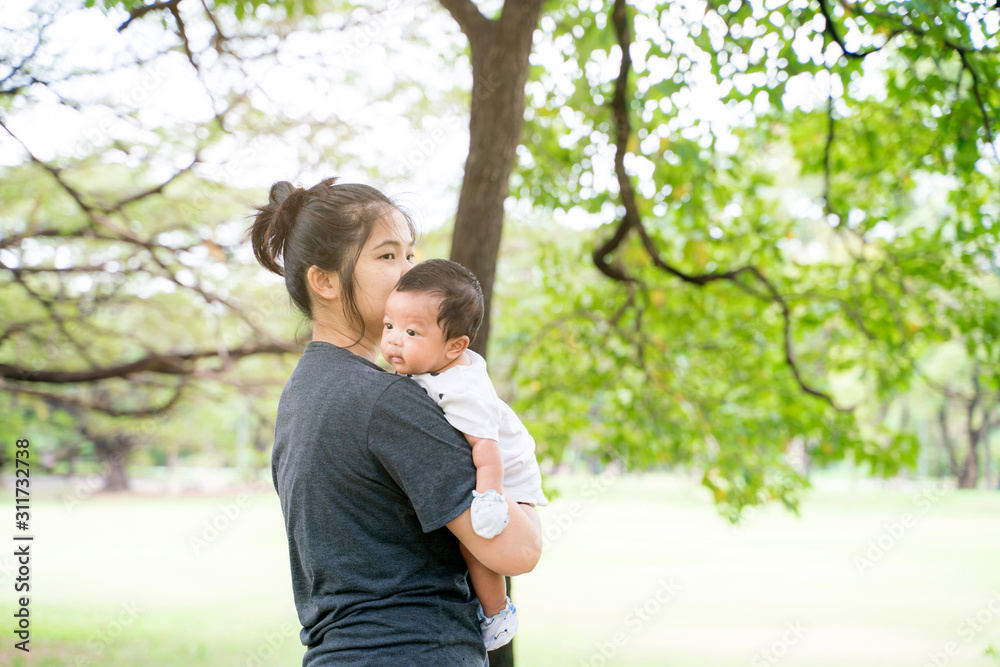 Mother with baby son leisure in city public park Mother with baby son leisure in city public park