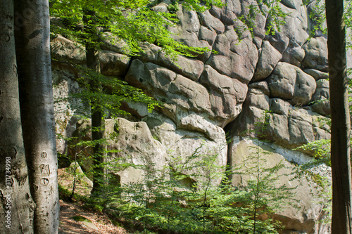 beautiful girl tourist with a backpack on a cliff, mountains, rocks Dovbush, Ukraine