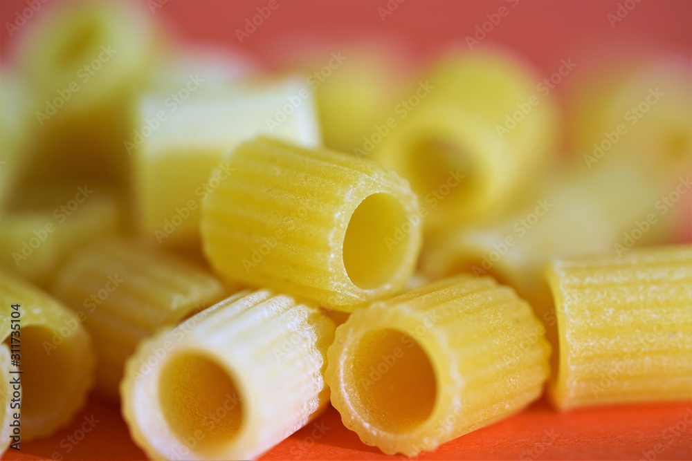 Macro view on uncooked traditional Italian pasta tubes ditaloni rigati