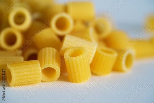 Close up view on dry Italian ditaloni pasta on white background photo