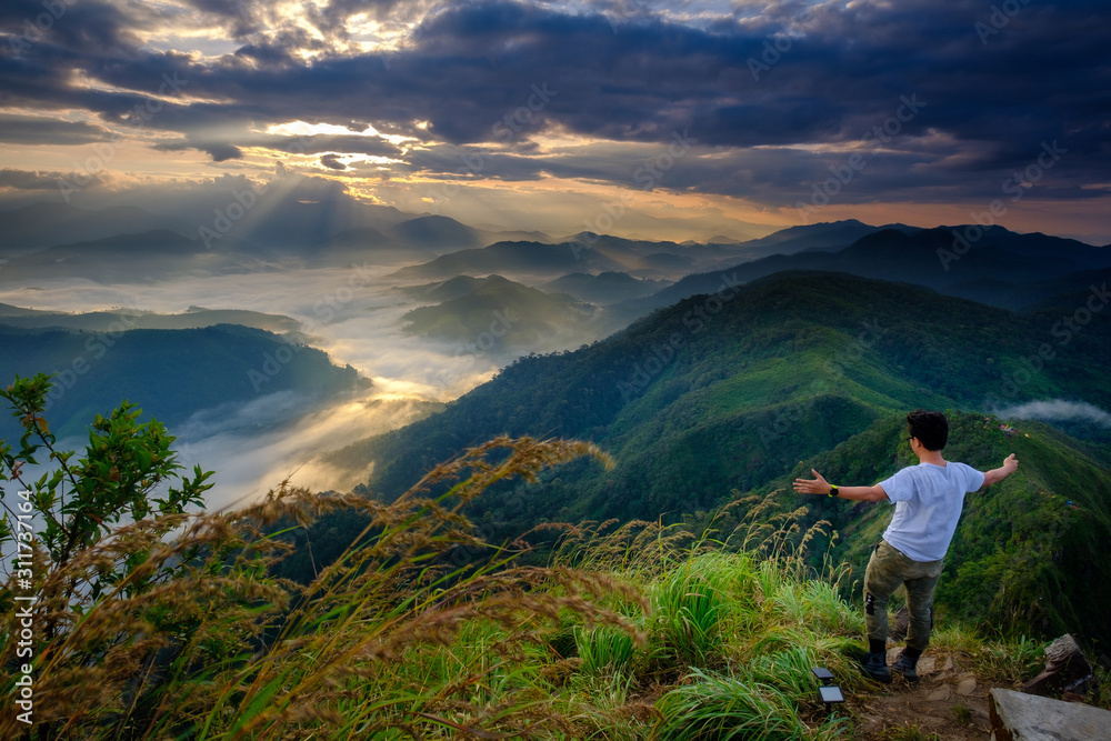 A man standing on top of the mountain view in the morning in Lerkwador, Tak province, Thailand