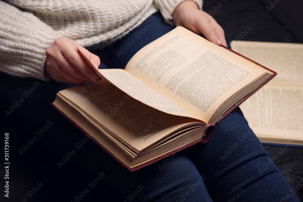Young woman reading book at home, closeup Young woman reading book at home, closeup