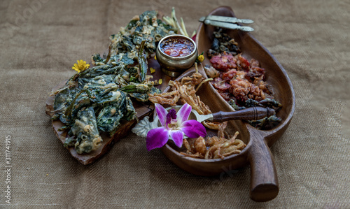 Crispy Flowers, Crispy Herbs and Crispy Vegetables served  with Sweet sauce in a Wooden tray.