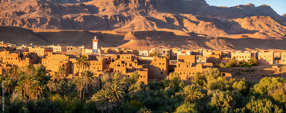 Obraz premium Morocco, traditional clay brick buildings mix perfectly with modern constructions in Tinehir