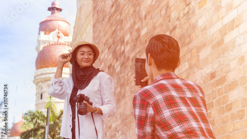 Photography Muslim Tourist Couple at Kuala Lumpur taking photo using smartphone