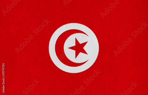 National flag of Tunisia on a cotton texture background