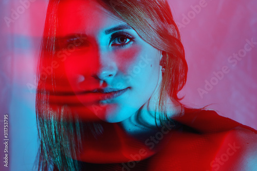 Weird two color light portrait of a young woman