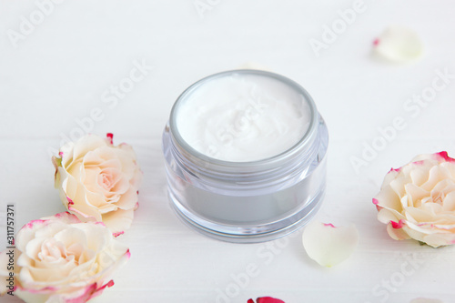 skincare cream and flowers on the table. Cosmetics for skin care.