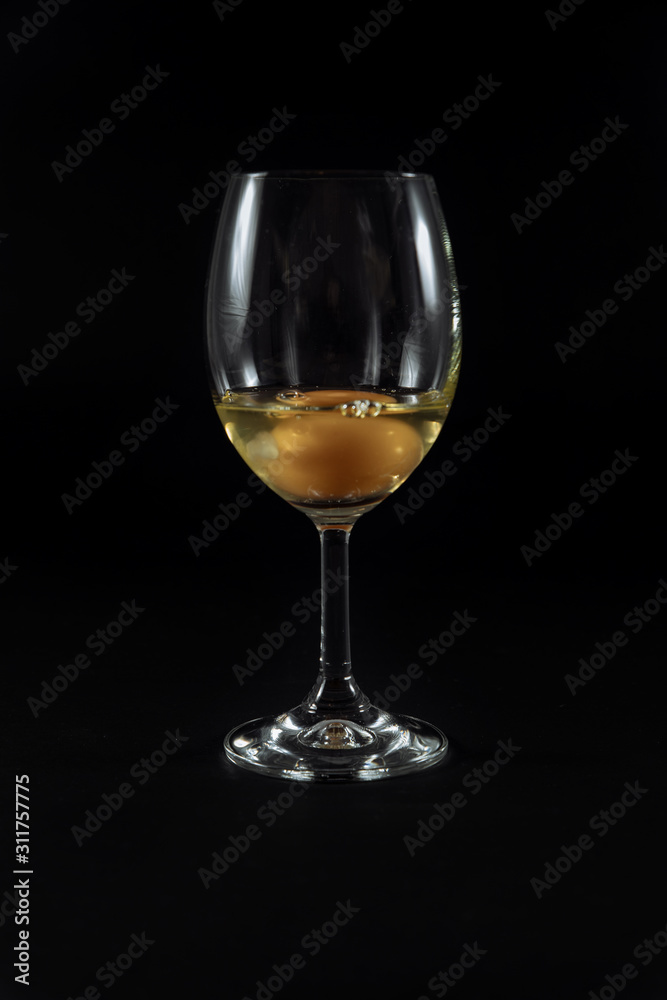 .egg in a glass, onion on black background glued with adhesive tape .egg in a glass, onion on black background glued with adhesive tape
