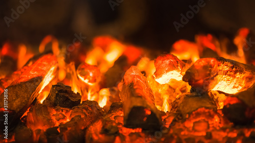 Canvastavla Abstract background of glowing orange red-hot wooden charcoal closeup at summer night