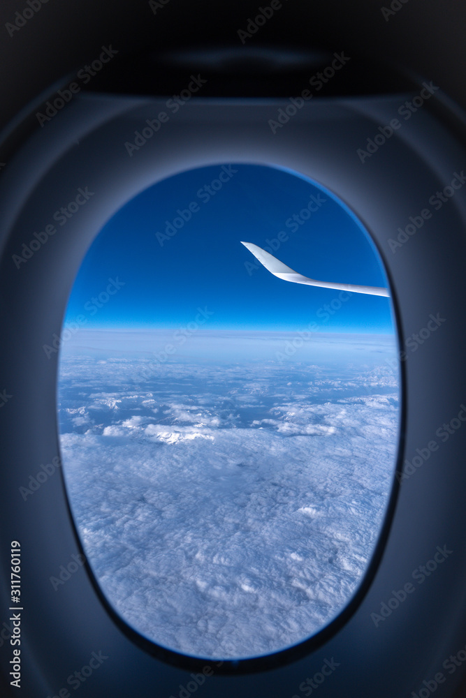 The layer of clouds and the horizon seen from the plane window The layer of clouds and the horizon seen from the plane window