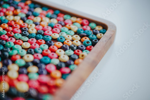 colorful beads on a wooden plate