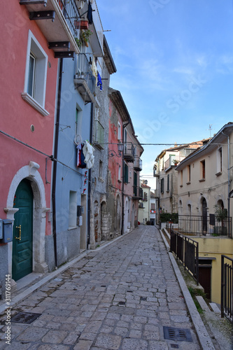 Fototapeta Naklejka Na Ścianę i Meble -  Campobasso, Italy, 12/24/2019. A narrow street between the alleys and buildings of a medieval city