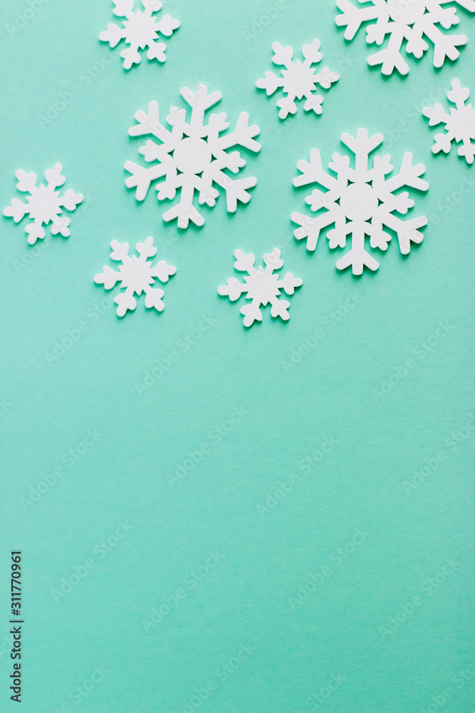 Christmas background for text or design. Wooden snowflakes on a blue background. Popular color 2020 year. Wooden white snowflakes of different sizes. Christmas background for text or design. Wooden snowflakes on a blue background. Popular color 2020 year. Wooden white snowflakes of different sizes.