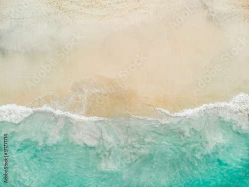 Top view of beautiful white sand beach with turquoise sea water and palm trees, aerial drone shot,