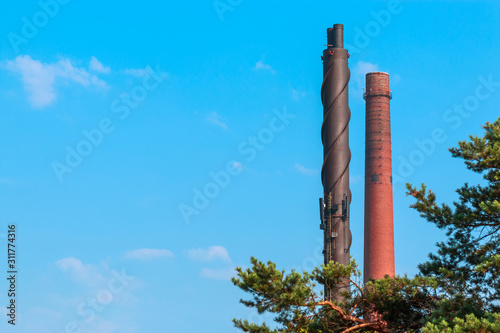 Pipes of a factory against the sky in the city of Kotka in Finland.