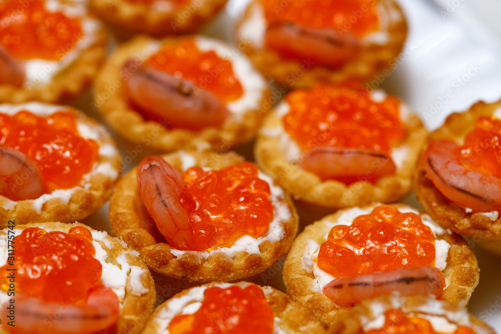tartlets with red caviar on a plate tartlets with red caviar on a plate