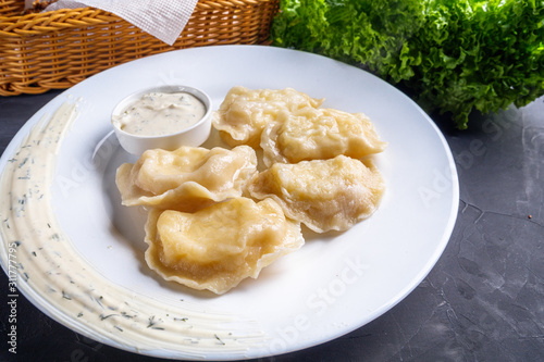 traditional Ukrainian dish of dumplings with sour cream photo