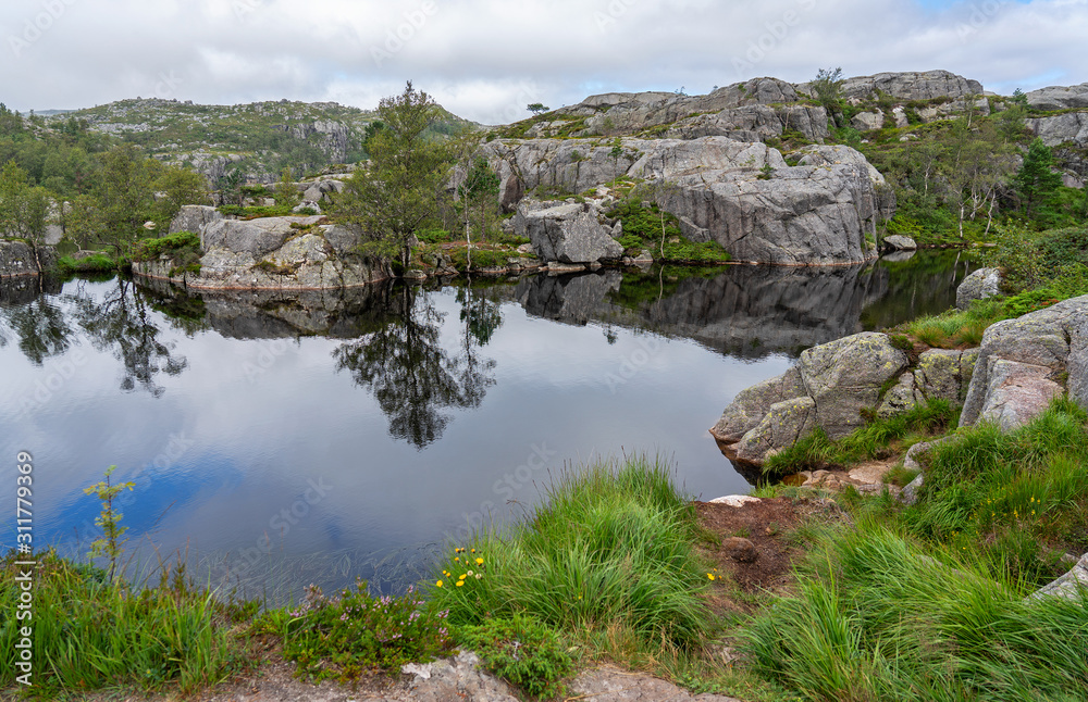 Mountain lake landscape view, Norway. Tourist way to Preikestolen rock.