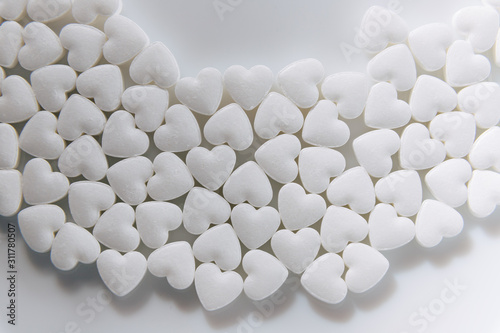 Tablets. Candies. Heart shaped pills. A lot of little hearts.