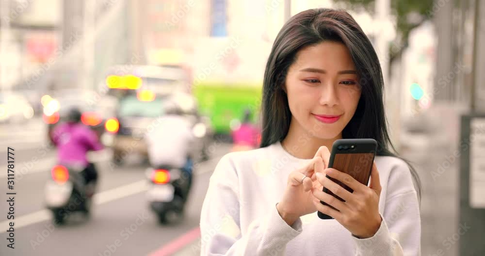 young Woman looking smart phone in the city at night young Woman looking smart phone in the city at night