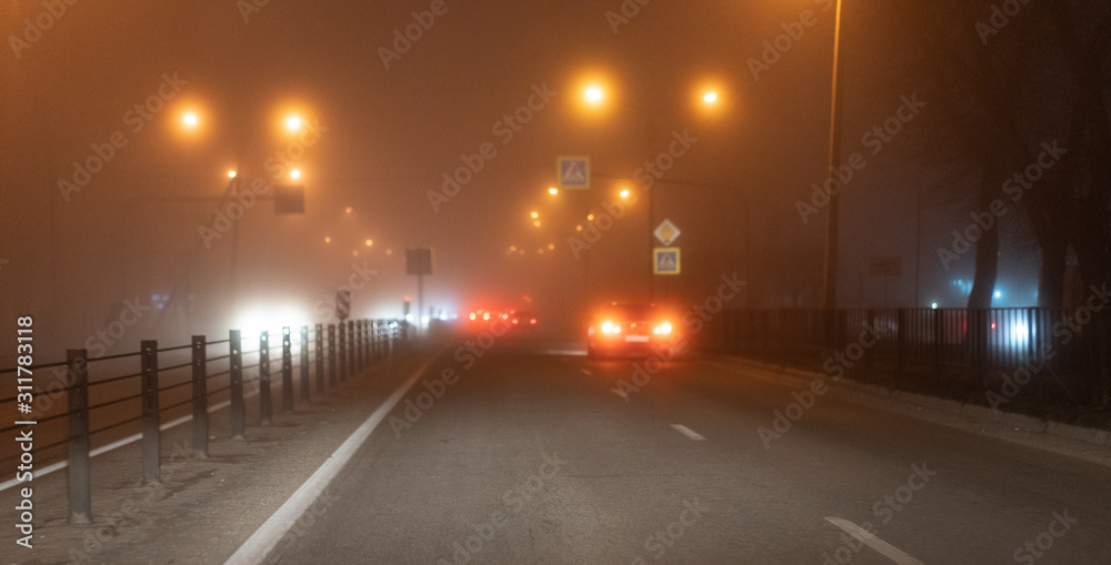 Traffic at an intersection in the fog