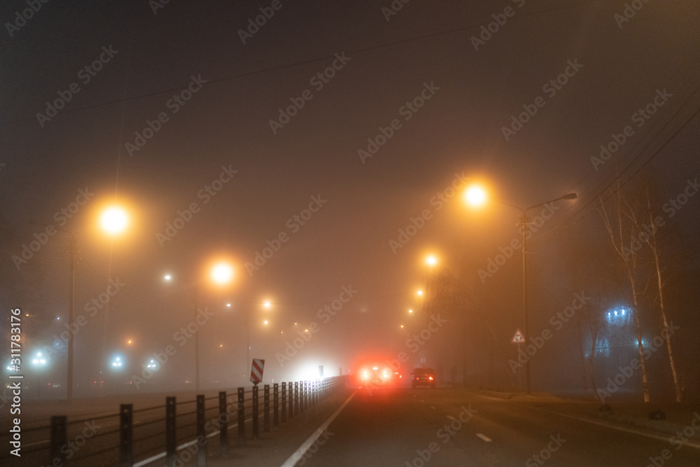 Cars ride in the fog at night