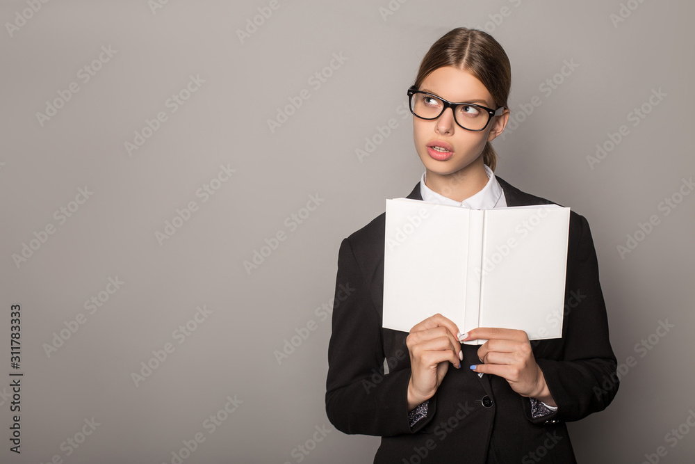 pensive businesswoman holding notebook isolated on grey pensive businesswoman holding notebook isolated on grey