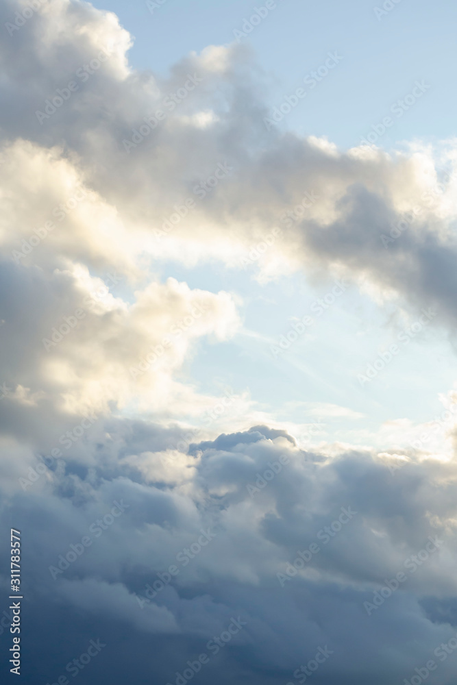 Amazing dark grey and white clouds during the sunset contrasted against a lighter color sky. Amazing dark grey and white clouds during the sunset contrasted against a lighter color sky.