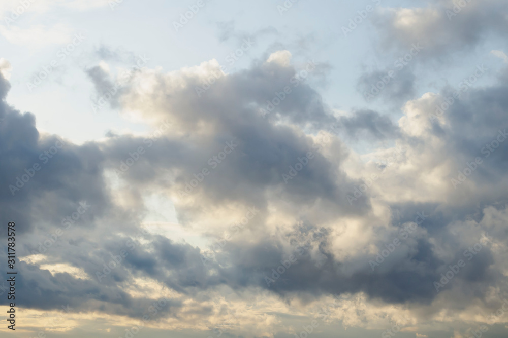 Amazing dark grey and white clouds during the sunset contrasted against a lighter color sky. Amazing dark grey and white clouds during the sunset contrasted against a lighter color sky.