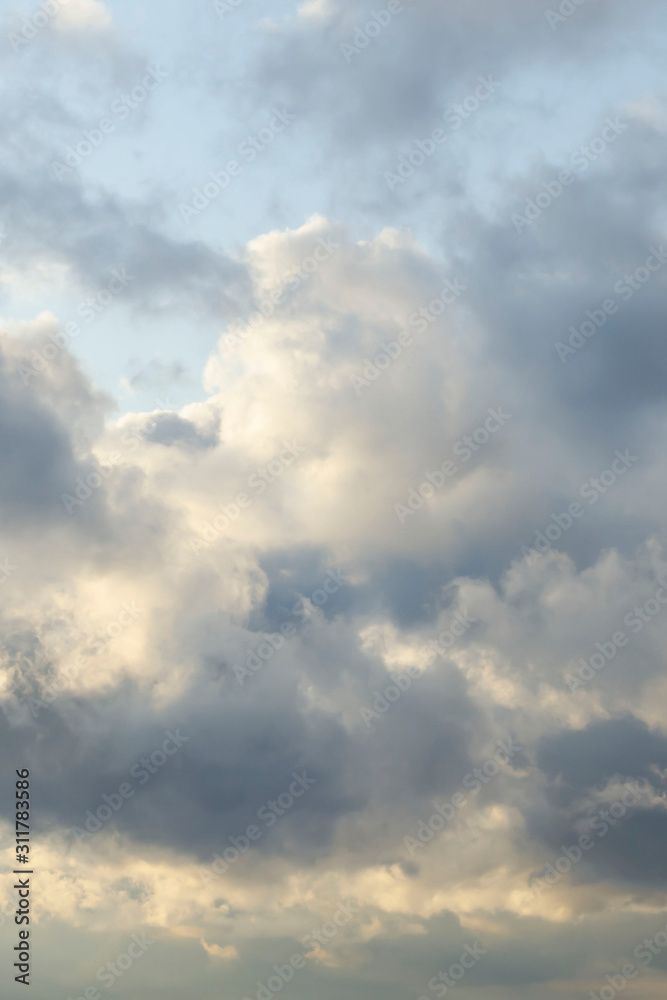 Amazing dark grey and white clouds during the sunset contrasted against a lighter color sky. Amazing dark grey and white clouds during the sunset contrasted against a lighter color sky.