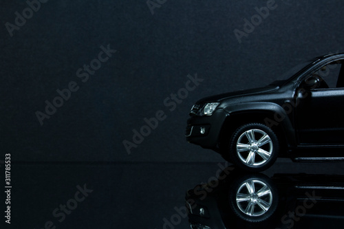 the front of a model copy of the Amarok on a black background and reflective surface. photo