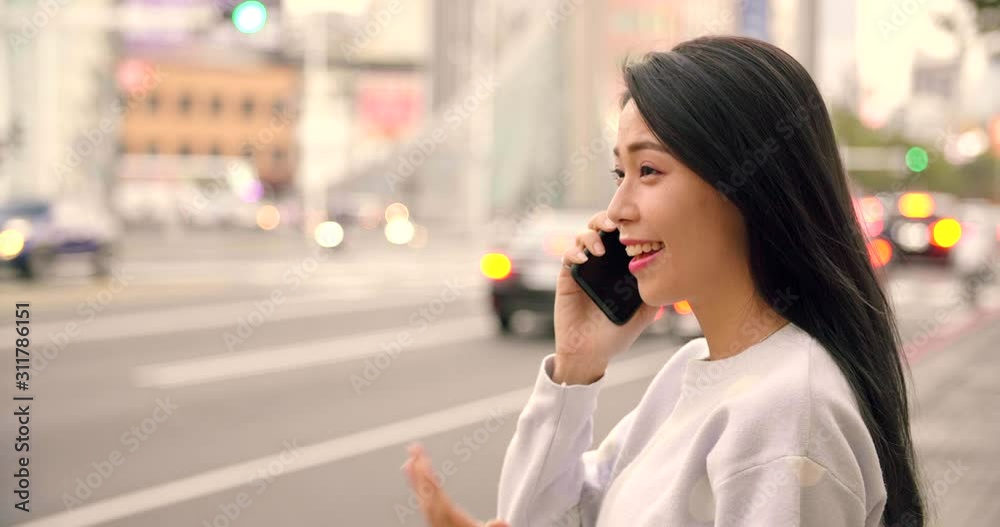 young Woman looking smart phone in the city at night young Woman looking smart phone in the city at night