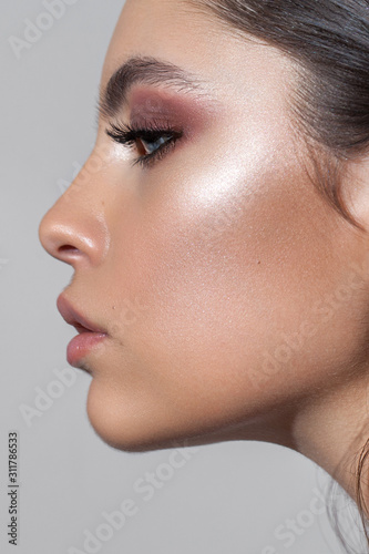 Canvas Print Profile photo of a beautiful girl with professional makeup, ideal skin, rose eyeshadows and nude lips