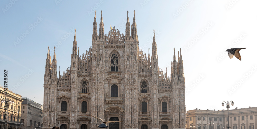 Milan, Italy. View of the Milan Cathedral with a flying bird