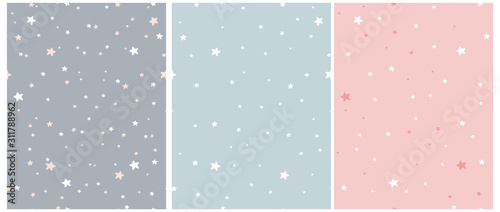 Tiny Stars Seamless Vector Patterns.Irregular Hand Drawn Simple Starry Print for Fabric,Textile,Wrapping Paper. Infantile Style Galaxy Design.Little Stars Isolated on a Gray, Blue and Pastel Pink. 