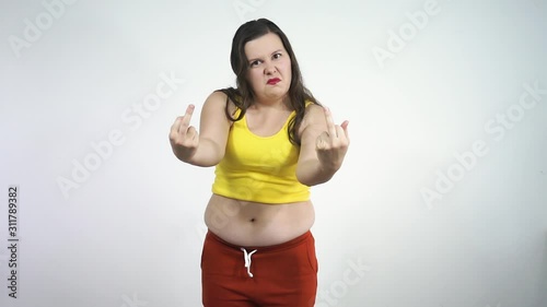 Fat girl touches her belly and aggressively shows fuck to the camera