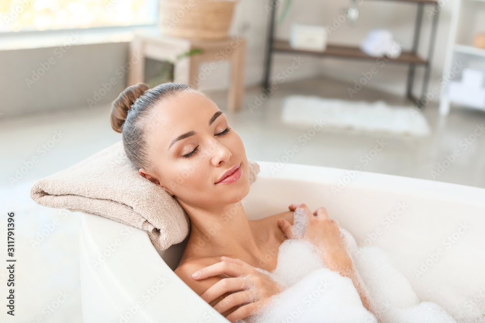 Beautiful young woman relaxing in bathtub Beautiful young woman relaxing in bathtub
