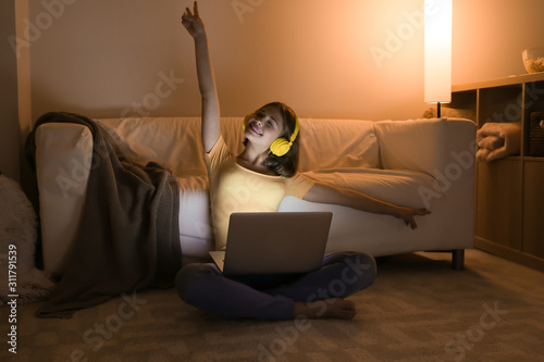 Teenage girl with laptop li...