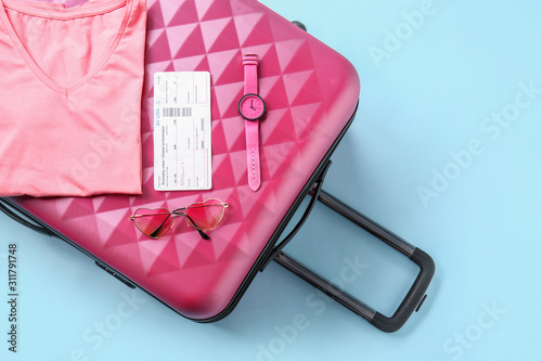Suitcase with ticket, cloth...